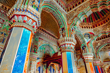 Thanjavur, Tamil Nadu, India - The high arches artworks and colorfully painted wall murals and ceilings of the ancient 17th-century durbar hall Maratha Palace in the town of Thanjavur