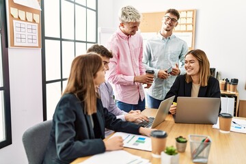 Group of business workers smiling happy working at the office.