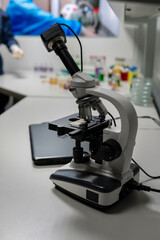 Microscope on table for science background. Medicine, pharmacist. glass jars, flasks and tools, Selective focus. Copy space. Vertical photo