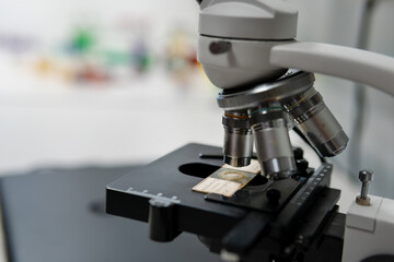 Microscope on table for science background. Medicine, pharmacist. glass jars, flasks and tools, Selective focus. Copy space