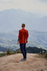 Fototapeta premium Man standing on a high viewpoint in Doi Inthanon park