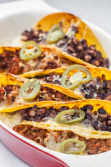 tacos filled with minced meat and black beans
