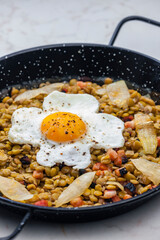 lentils with smoked meat and onion served with fried egg