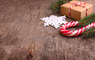 Christmas background with decorations and gift boxes on wooden board.