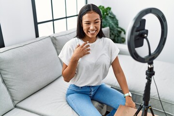 Fototapeta na wymiar Young latin woman smiling confident recording video at home