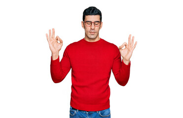 Naklejka premium Handsome hispanic man wearing casual clothes and glasses relax and smiling with eyes closed doing meditation gesture with fingers. yoga concept.