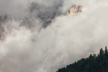 The northern side of Sella group among the clouds from the Val Gardena area