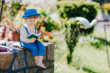 Fototapeta premium figurine of a boy in a garden