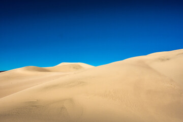Fototapeta na wymiar Fine Line Divide The Bright Blue Sky and Panamint Dunes