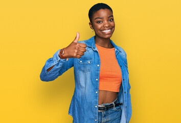 Young african american woman wearing casual clothes doing happy thumbs up gesture with hand....