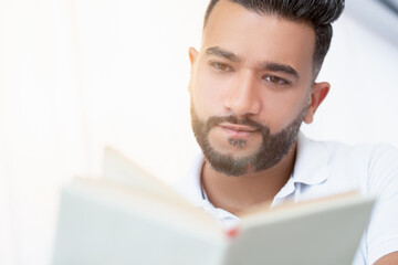 Interesting book. Involved man. Enjoying time. Handsome arabian guy reading isolated white background.