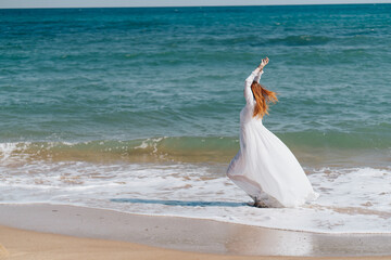 Fototapeta na wymiar woman silhouette in a white dress by the ocean Fresh air