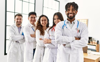 Fototapeta premium Group of young doctor smiling happy standing with arms crossed gesture at the clinic office.