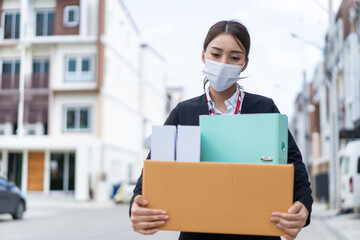 Asian business woman wear face mask after unemployment from company. 