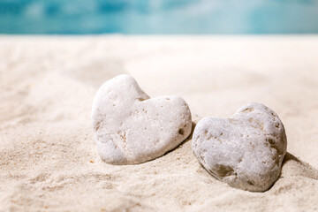 Fototapeta na wymiar Summer sand sea beach with waves and heart stones