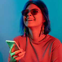 Phone entertainment. Millennial lifestyle. Mobile technology. Joyful laughing woman using...