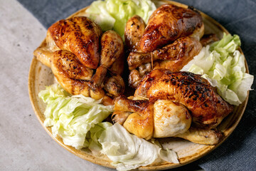 Grilled mini chicken with green salad on plate