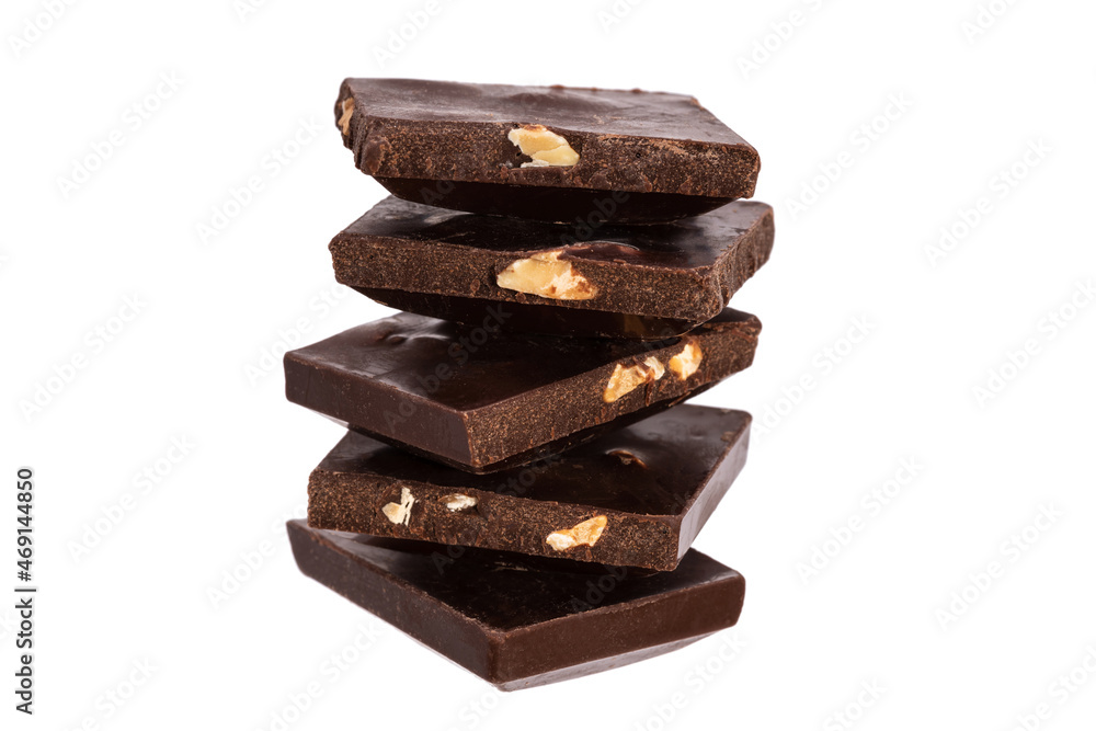 Poster pieces of dark chocolate with nuts stacked in a vertical row isolated on white background