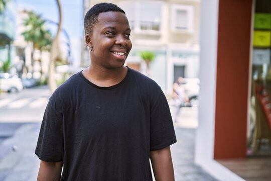 Young african american transgender smiling confident at street