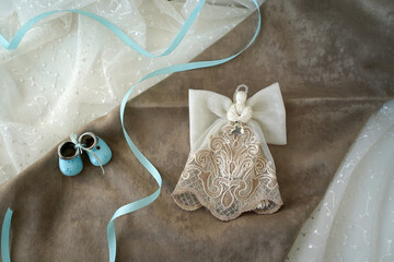 delicate lace angel with a heart on a brown cloth. gift for mom of a newborn baby.