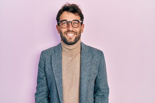 Handsome man with beard wearing business jacket and glasses with a happy and cool smile on face. lucky person.