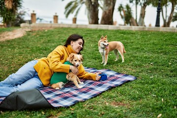 Beautiful young woman walking with shiba inu dog at park