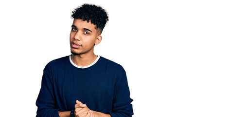 Young african american man wearing casual clothes with hands together and crossed fingers smiling relaxed and cheerful. success and optimistic