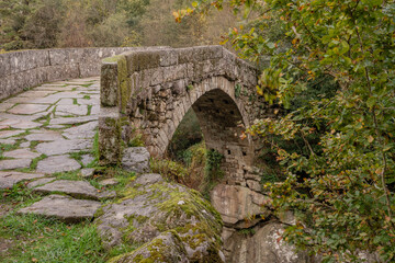 Fototapeta na wymiar Ancient stone bridge. Misarela Bridge also known as Devil Bridge in Peneda Geres National Park, Portugal. Over Rabagão river. 