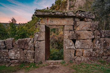 Fototapeta na wymiar Old stone door entrance to forest landscape