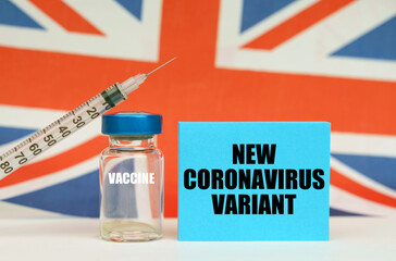 Syringe and blue plate with the inscription - NEW CORONAVIRUS VARIANT. In the background the flag...