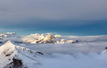 View from the summit of mountain Schilthorn in the Swiss Alps Switzerland at sunrise with dramatic clouds and fresh snow.