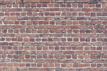 Weathered brick stone wall in warm tones