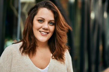 Fototapeta premium Young irish plus size girl smiling happy standing at the city.