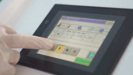 A worker or an engineer controlling the machine in factory.