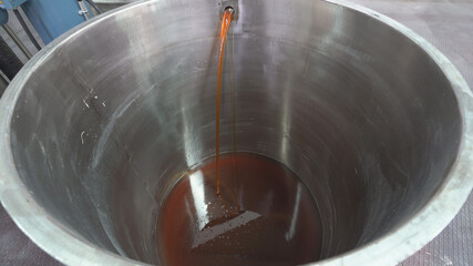 Making industrial point.The point machie fill up  on production line. Yellow point.