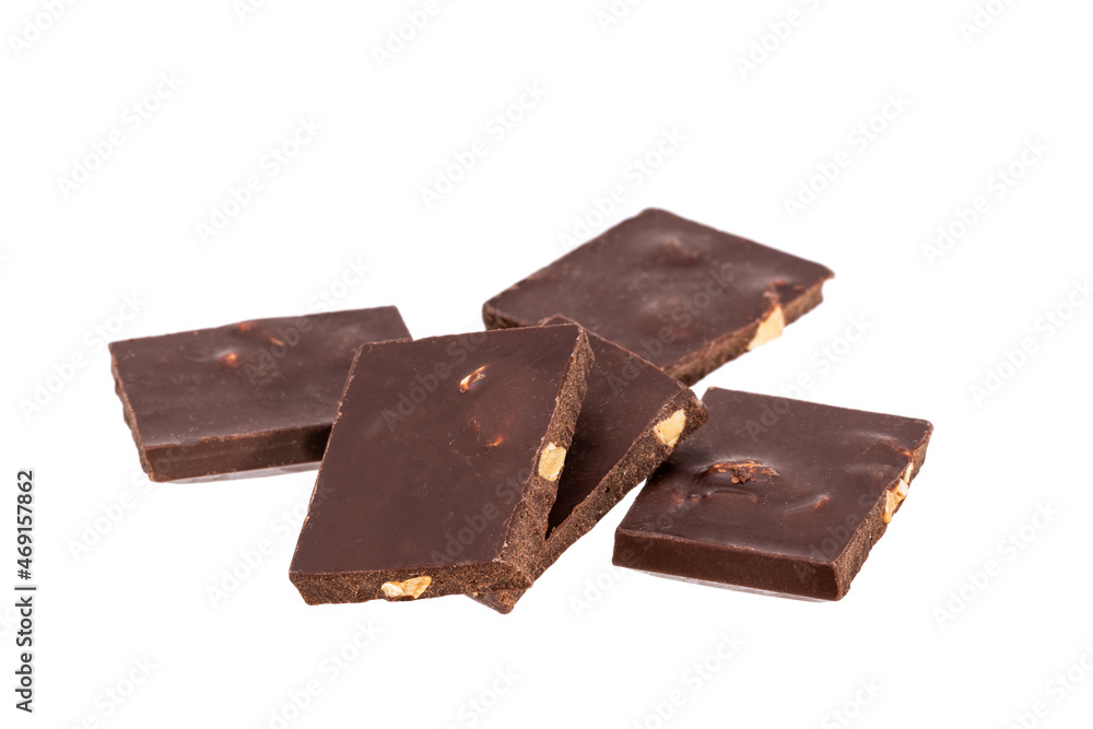 Aufkleber broken pieces of dark chocolate with nuts in a heap isolated on white background