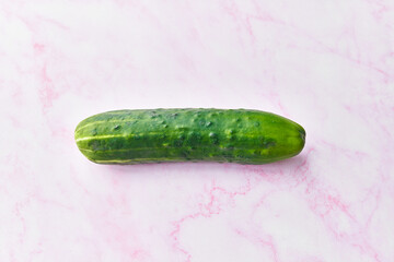  Single cucumber on a marble surface