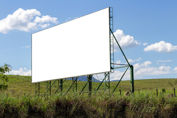 Billboard on the road. green grass and blue sky composing the landscape