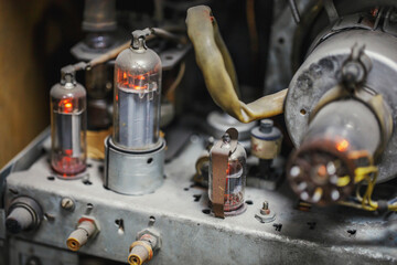 The vacuum tubes in an old tube TV are dusty in working order. The internal structure of technology...