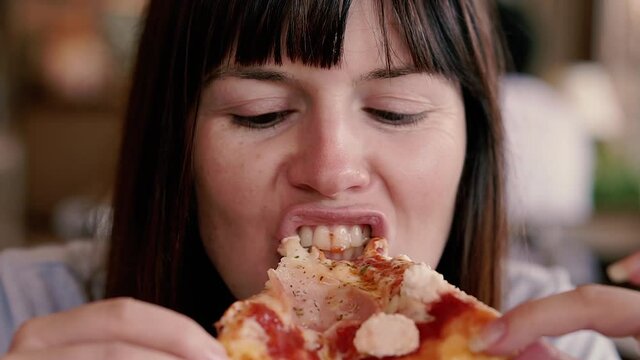Pizza. The woman is eating pizza.