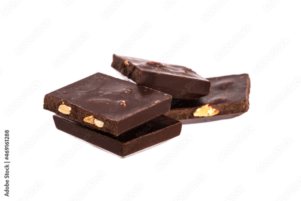 Poster pieces of chocolate with nuts in a heap isolated on white background