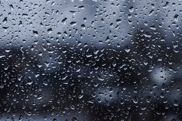 Abstract blurred background. Raindrops on the glass against the background of the city. Autumn. selective focus