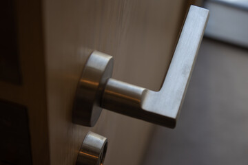 Stainless steel Door handle in Satin nickel finish, Selective focus.