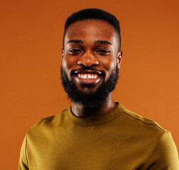 young pretty african american man posing cheerful on brown background, lifestyle people concept