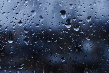 Abstract blurred background. Raindrops on the glass against the background of the city. Autumn. selective focus