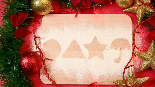 Cutting board with poured powder sugar and shapes of squid game dalgona candies