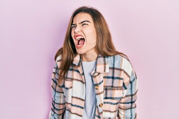 Young caucasian girl wearing casual clothes angry and mad screaming frustrated and furious, shouting with anger. rage and aggressive concept.