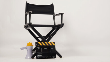 Black director chair and Clapper board with yellow megaphone on white background
