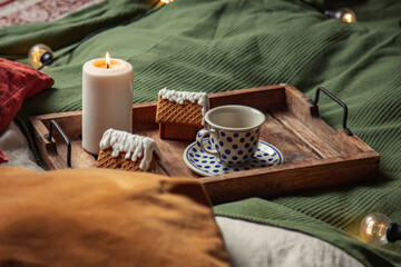 Cup of coffee and Christmas cookies in a bed