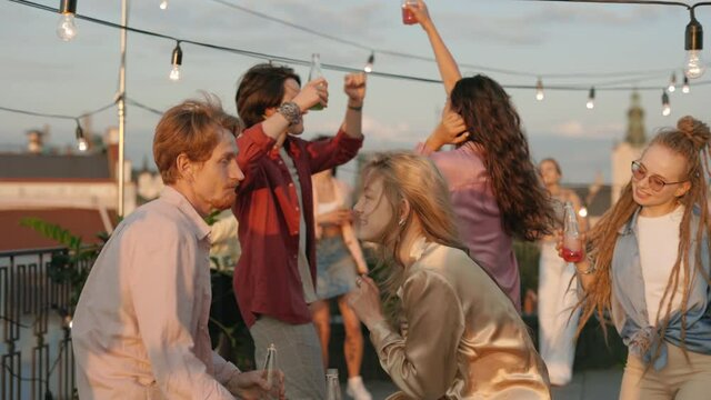 Group of multi ethnic people having fun on rooftop party
